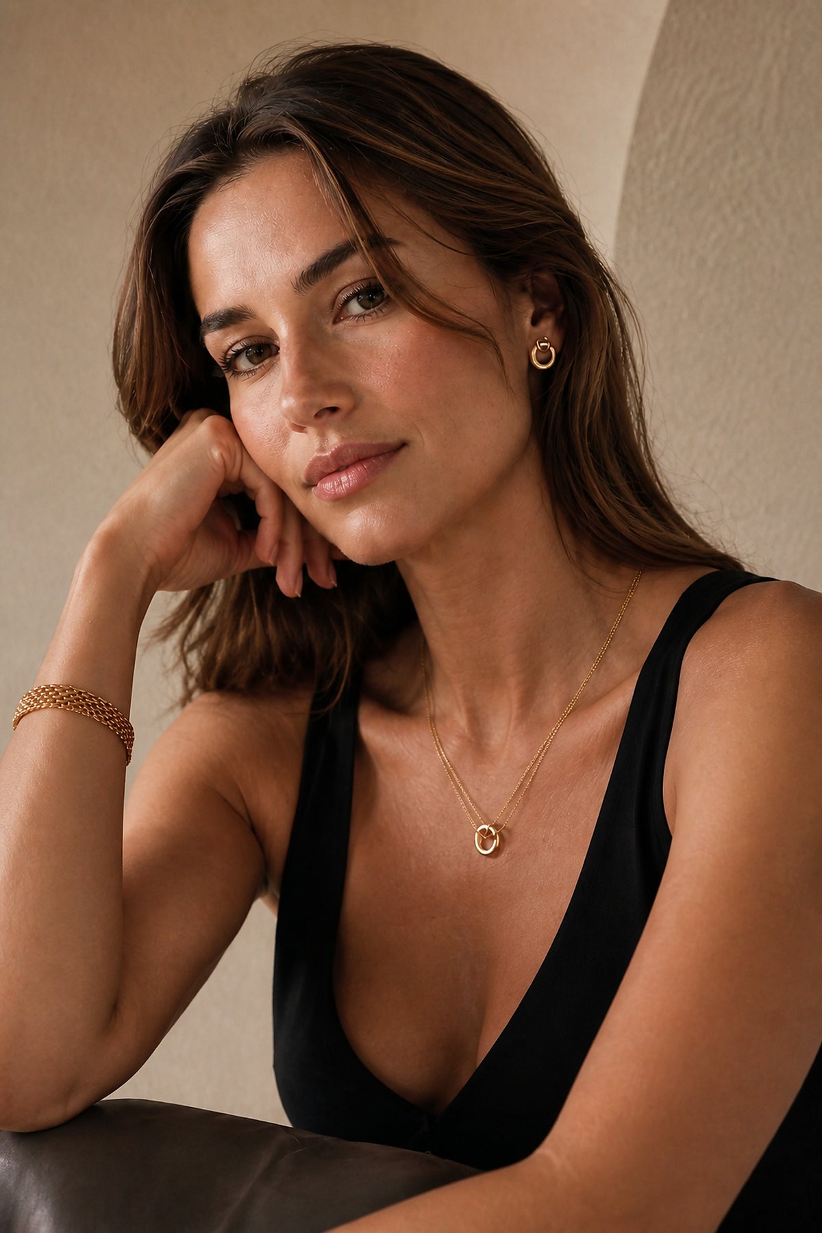 Woman wearing layered necklace, earrings, and bracelet