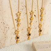 Women's Star Necklace with Multiple Charms and Asymmetrical Star Design